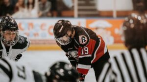 Close-up action scene of ice hockey players in full gear competing on an indoor rink., tags: nhl - pexel