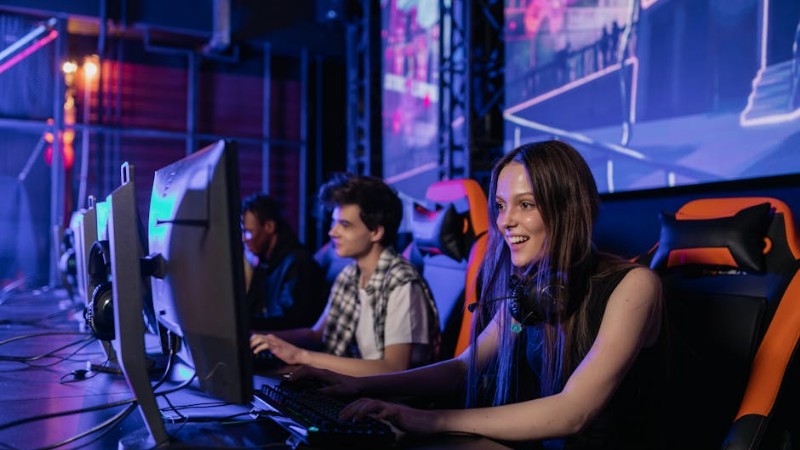 A group of young adults enjoying a gaming session in a vibrant esports arena. - A group of young adults enjoying a gaming session in a vibrant esports arena., tags: betting - pexel