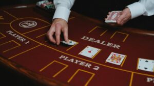 A casino dealer distributes playing cards at a poker table, ready for a game. - pexel