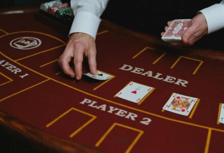 A casino dealer distributes playing cards at a poker table, ready for a game. - pexel