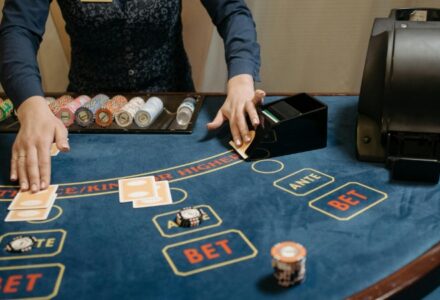 Casino dealer organizing cards and chips on a gaming table during a game., tags: beginner-friendly online - pexel