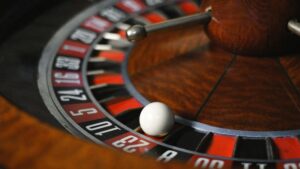 Detailed close-up image of roulette wheel highlighting numbers and spinning ball in a casino setting., tags: games - pexel