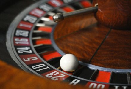 Detailed close-up image of roulette wheel highlighting numbers and spinning ball in a casino setting., tags: games - pexel