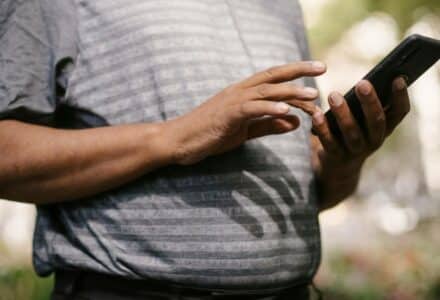 Crop anonymous male in casual clothes using smartphone on blurred background of street, tags: ontario gambling - pexel