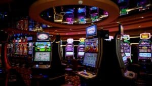 Vibrant casino floor with colorful slot machines and bright lights capturing a lively gaming atmosphere., tags: playtech - pexel