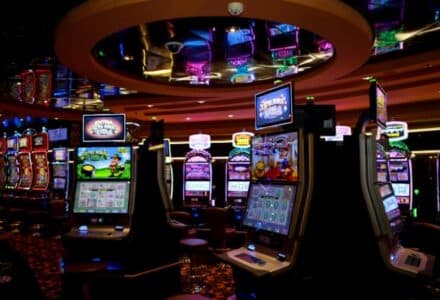 Vibrant casino floor with colorful slot machines and bright lights capturing a lively gaming atmosphere., tags: playtech - pexel