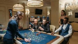 A diverse group of adults enjoying a night at the casino, playing roulette indoors., tags: canadian - pexel