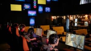 Group of gamers participating in an online tournament at a modern internet cafe., tags: gambling - pexel