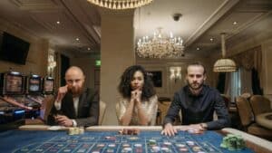 A diverse group of adults sitting at a casino gaming table with chips and cards in a luxurious setting., tags: pointsbet - pexel