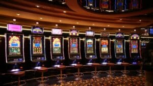 A row of luxury slot machines in a casino interior with plush stools, perfect for gaming enthusiasts., tags: money slots - pexel